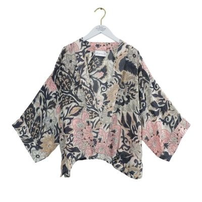 A patterned long-sleeve kimono with an all-over floral design of pink flowers with black and taupe leaves.