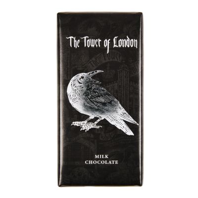 A chocolate bar packaged in a black and silver foil wrapper with an illustration of a raven and the White Tower in the background. 