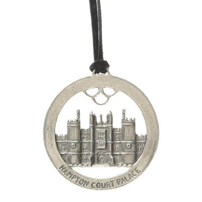 A round, metal hanging decoration with Hampton Court Palace in the centre 