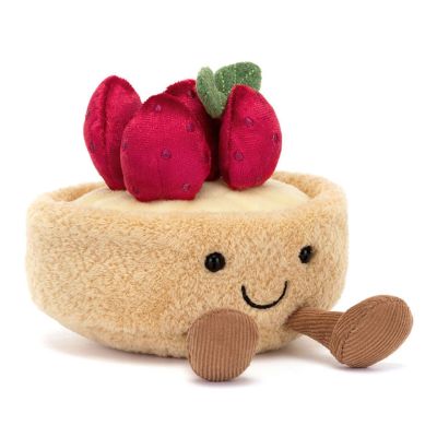 A plush soft toy in the shape of a strawberry tarte with four velvety plush, red strawberries on the top and an embroidered smiley face. 
