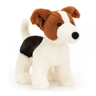 A soft plush Jellycat toy in the shape of a Jack Russell dog in brown, white and black. The dog is standing on four legs, the tips of his ears are flopped over and his white tail is upright. 