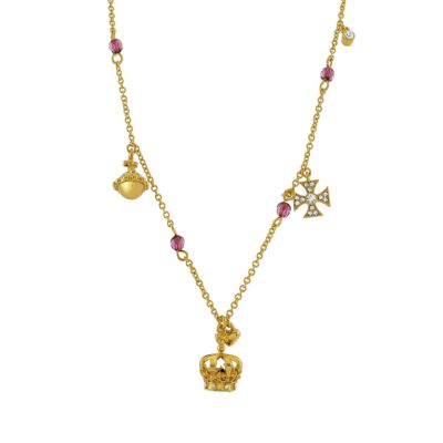 A gold necklace with a crown pendant and mini gold charms hanging from the chain. 