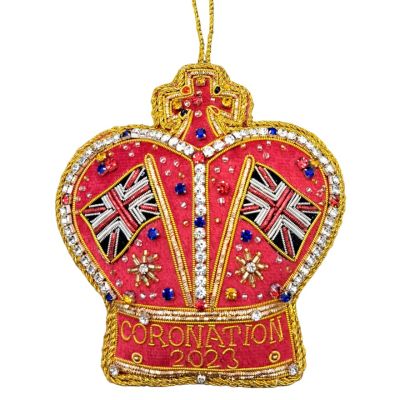 A red fabric crown hanging decoration with coloured beads. Coronation 2023 text is embroidered on the front 