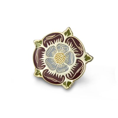 An enamelled metal pin badge in the shape of a Tudor rose in a deep red with green details. 