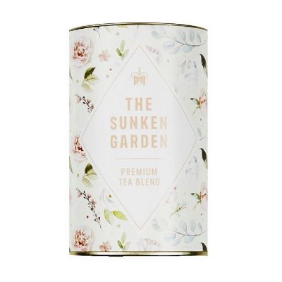 A circular tin of "The Sunken Garden, Premium blend tea" with a watercolour pattern of flowers and leaves on it. 