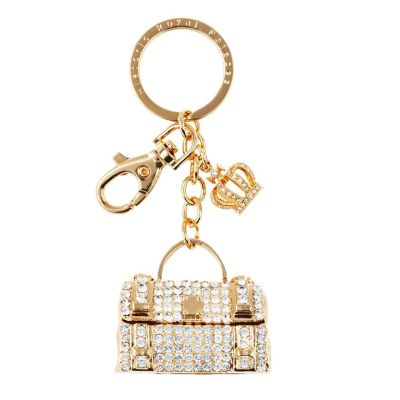 A gold and crystal keyring with a hanging charm in the shape of a clutch handbag and a mini royal crown. 