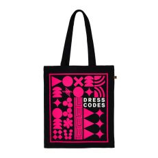 A black tote bag with a bright-pink print of various symbols and patterns. The text on the right-centre of the bag reads, "Dress Codes".