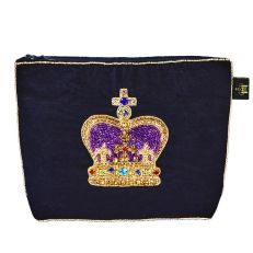 A dark navy velvet purse with a gold and purple embellished crown embroidered on one side. With a zip top closure. 