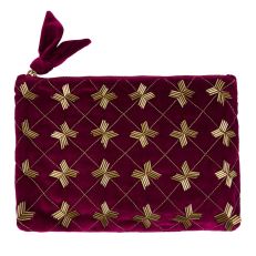 A purple quilted zipped purse with a deco beaded design stitched onto one side. 