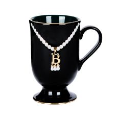 Black mug with gold and pearl 'B' pendant necklace