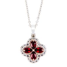 A quatrefoil shaped pendant with four pear-cut red garnet stones surrounded by small white topaz stones. Hung on a sterling silver chain. 