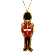 A red and black velvet hanging decoration in the shape of a Royal Guard complete with embroidered medals and lapels, and finished with gold thread. 