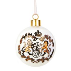 A white bauble with a gold crest from Kensington Palace printed on one side. The crest includes ornate K and P letters alongside a lion and a unicorn motif. 
