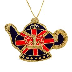 A teapot-shaped hanging decoration in a navy coloured velvet with a red and gold Union Jack design across the middle. In the centre is a gold crown motif made out of gold thread and beads. 