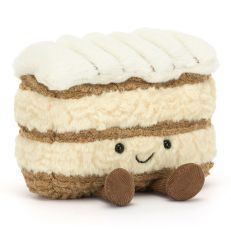 A soft plush toy in the shape of a mille feuille patisserie. With a embroidered face and dangly legs. 