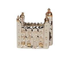 A silver charm bead in the shape of the White Tower at the Tower of London with delicate window details. The turrets are made from rose gold. 