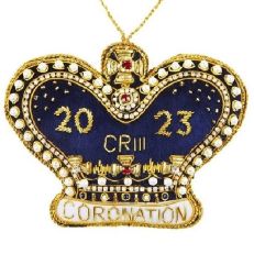 A crown shaped hanging decoration made of blue velvet and beads. '2023 CR III Coronation' text is sewn in gold thread