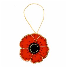 A red, plush velvet hanging decoration in the shape of a poppy, finished with glass beads and gold thread. 