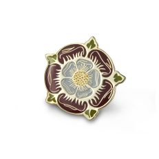 An enamelled metal pin badge in the shape of a Tudor rose in a deep red with green details. 