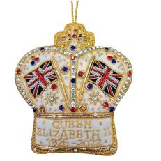 A white crown fabric hanging decoration with coloured gems and beads. Two Union Jacks are in the centre with 'Queen Elizabeth II 1926 - 2022' stitched in gold at the bottom