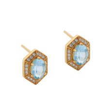 Gold stud earrings in a hexagon shape inlaid with sky-blue topaz stones and surrounded by cubic zirconia.