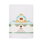 White tea towel folded with gold and blue crown detailing