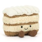 A soft plush toy in the shape of a mille feuille patisserie. With a embroidered face and dangly legs. 
