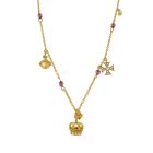 A gold necklace with a crown pendant and mini gold charms hanging from the chain. 