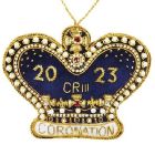A crown shaped hanging decoration made of blue velvet and beads. '2023 CR III Coronation' text is sewn in gold thread
