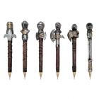 A set of medieval knight resin novelty pens in silver, gold and brown with various helmet designs. 