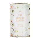 A circular tin of "The Sunken Garden, Premium blend tea" with a watercolour pattern of flowers and leaves on it. 