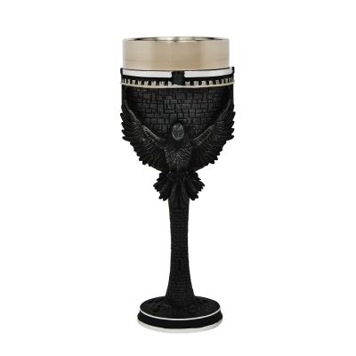 Stainless steel goblet with a black sculpted raven on medieval brickwork